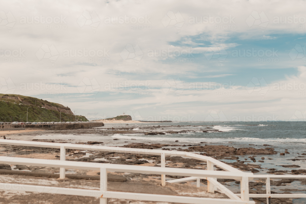 View from Newcastle Ocean Baths looking north towards Nobbys Beach and Nobbys Lighthouse - Australian Stock Image