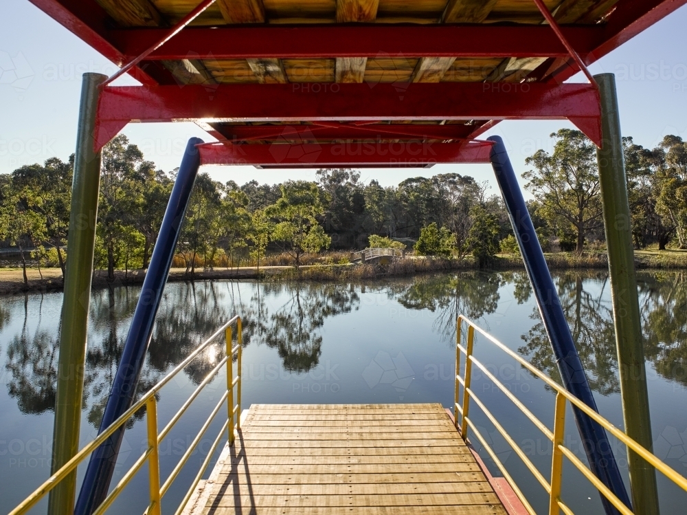 view looking out from a two-tiered diving platform onto a lake - Australian Stock Image