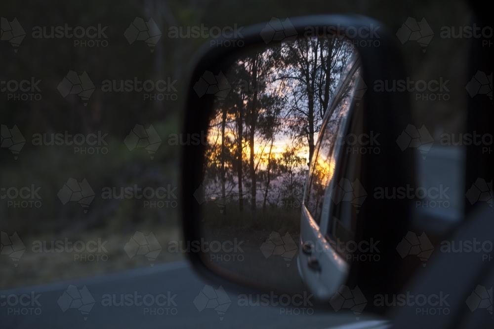 View of a sunset in a car mirror - Australian Stock Image