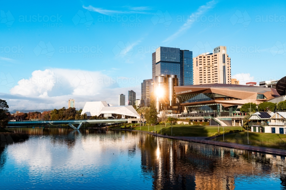 View of Adelaide city across the Torrens River with bright afternoon sunlight reflecting - Australian Stock Image
