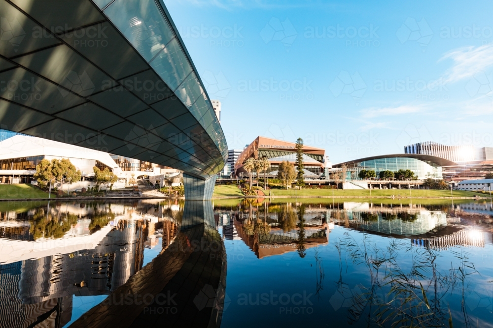 View of Adelaide city across the Torrens River with buildings reflected in water - Australian Stock Image
