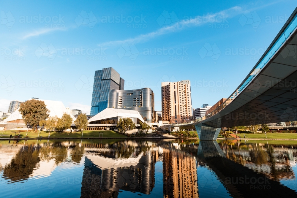 View of Adelaide city across the Torrens River with buildings reflected in water - Australian Stock Image