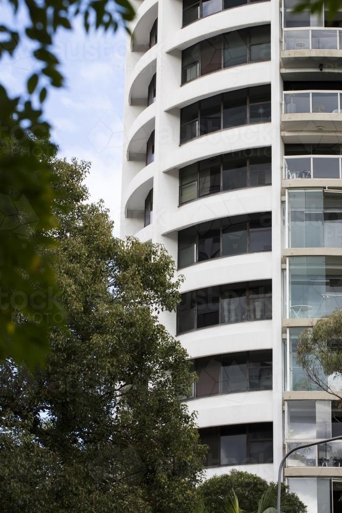 View of apartment building through trees darling point, sydney - Australian Stock Image