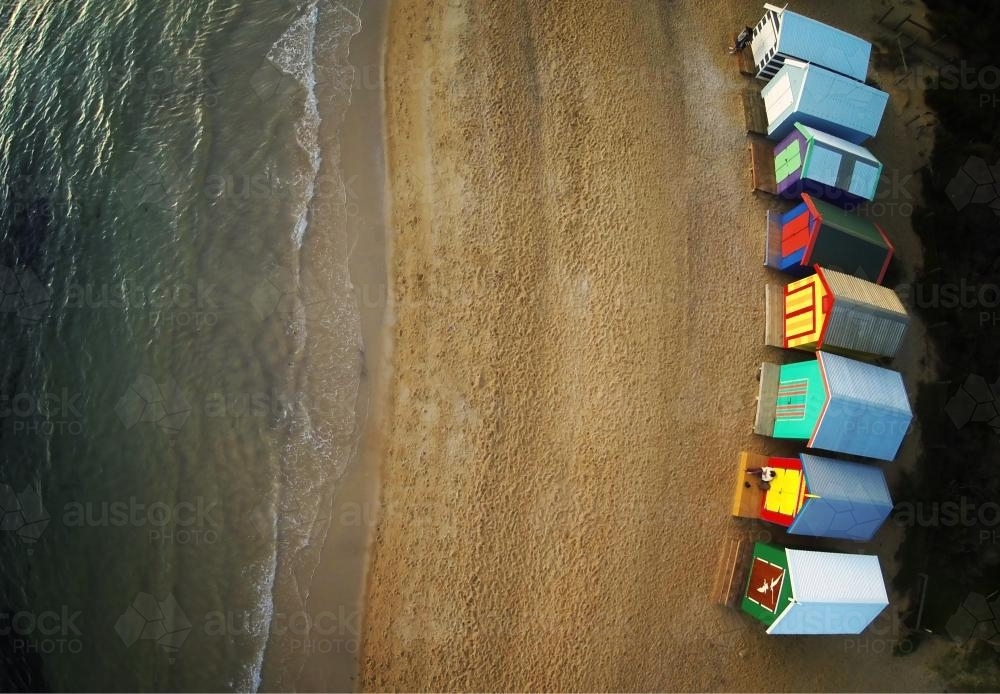 View of colourful beach boxes and ocean from above - Australian Stock Image