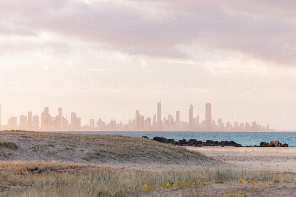 View of Gold Coast city skyline from Currumbin Beach at sunset - Australian Stock Image