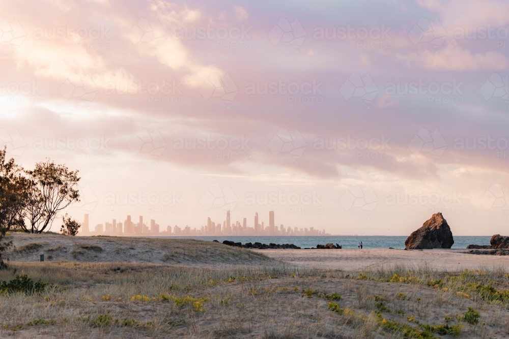 View of Gold Coast city skyline from Currumbin Beach at sunset - Australian Stock Image