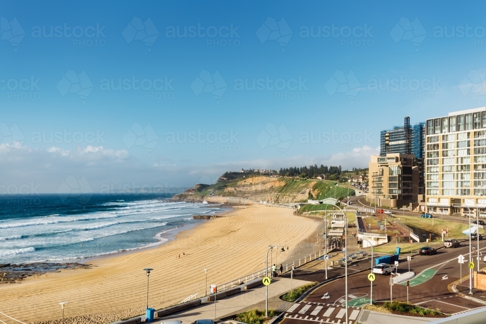 View of Newcastle beach from a balcony in the early morning - Australian Stock Image
