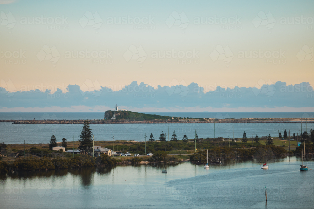 View of Nobby's Beach lighthouse from Stockton Bridge in Newcastle - Australian Stock Image