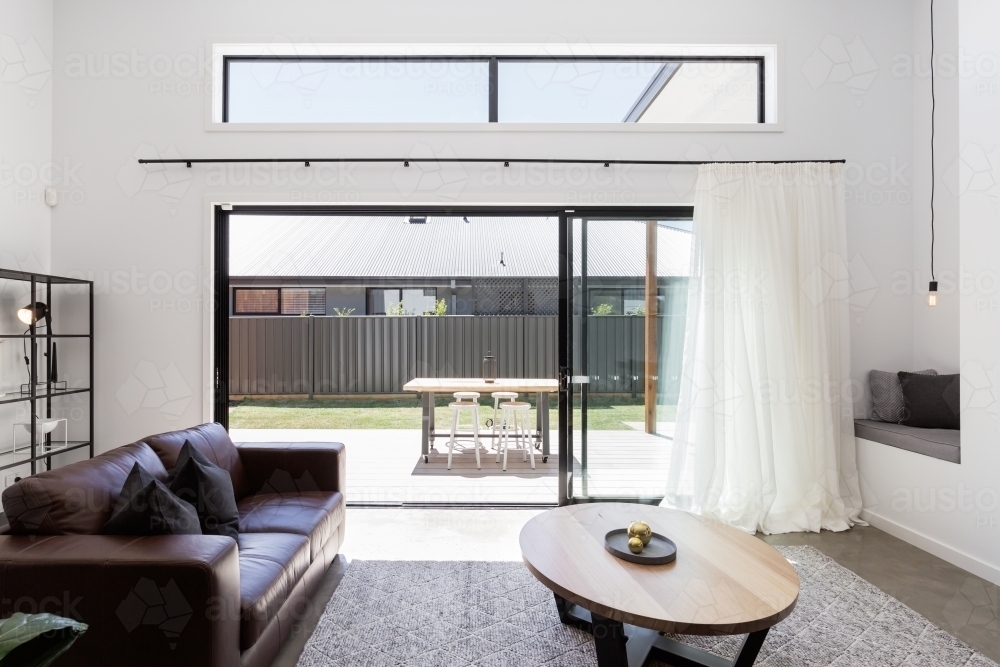 View of outdoor deck from a luxury living room - Australian Stock Image