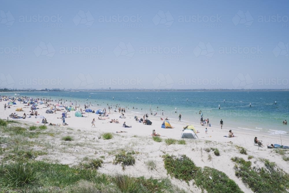 View of people enjoying a summers day at the beach - Australian Stock Image