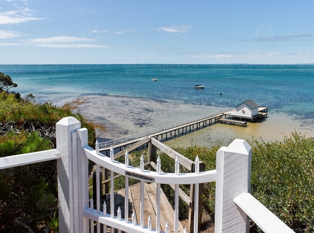 view of private jetty and boatshed from cliffside walk - Australian Stock Image