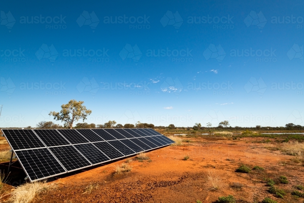 View of Solar Panels in desert desert landscape with clear blue sky - Australian Stock Image