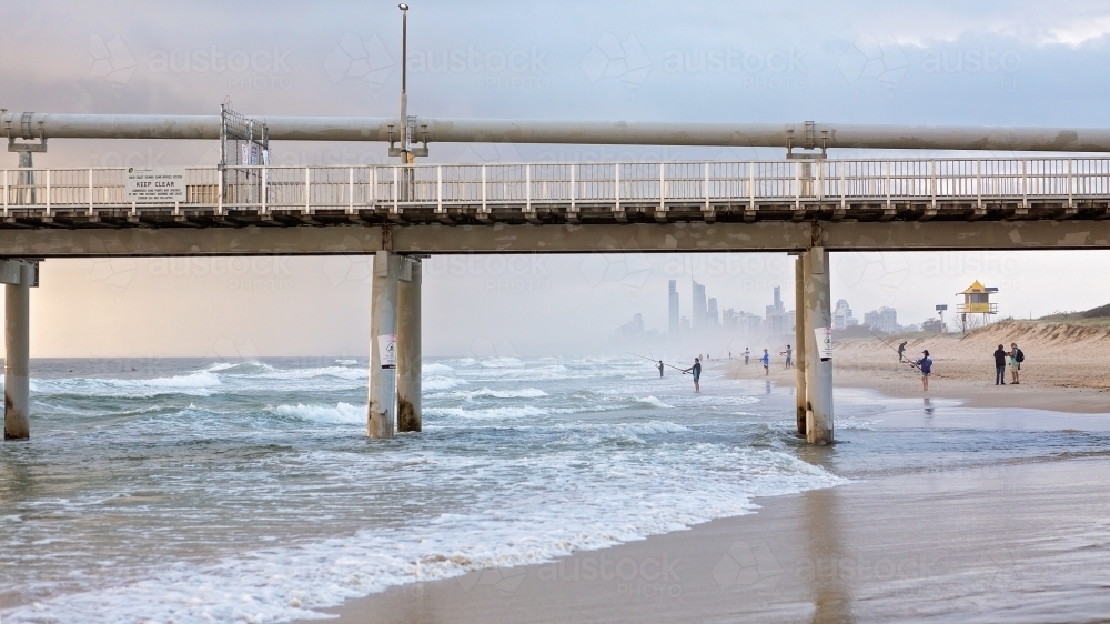 View of surfers paradise through sand pumping jetty at The Spit - Australian Stock Image