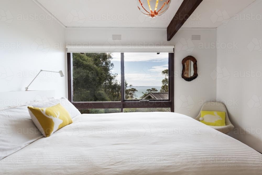 View of the ocean from a retro styled 70s bedroom - Australian Stock Image
