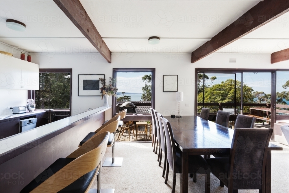 View of the ocean from retro 70s beach house dining room - Australian Stock Image