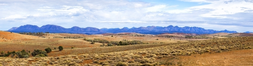 View of Wilpena Pound across rolling hills - Australian Stock Image