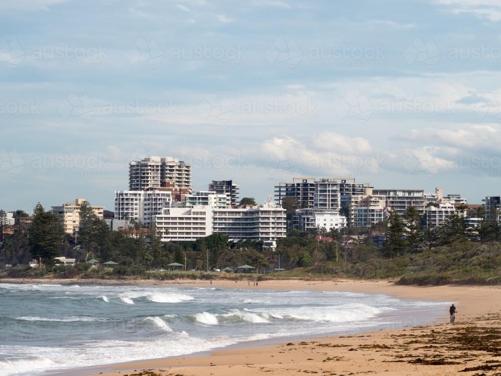 View of Wollongong across a beach and surf - Australian Stock Image