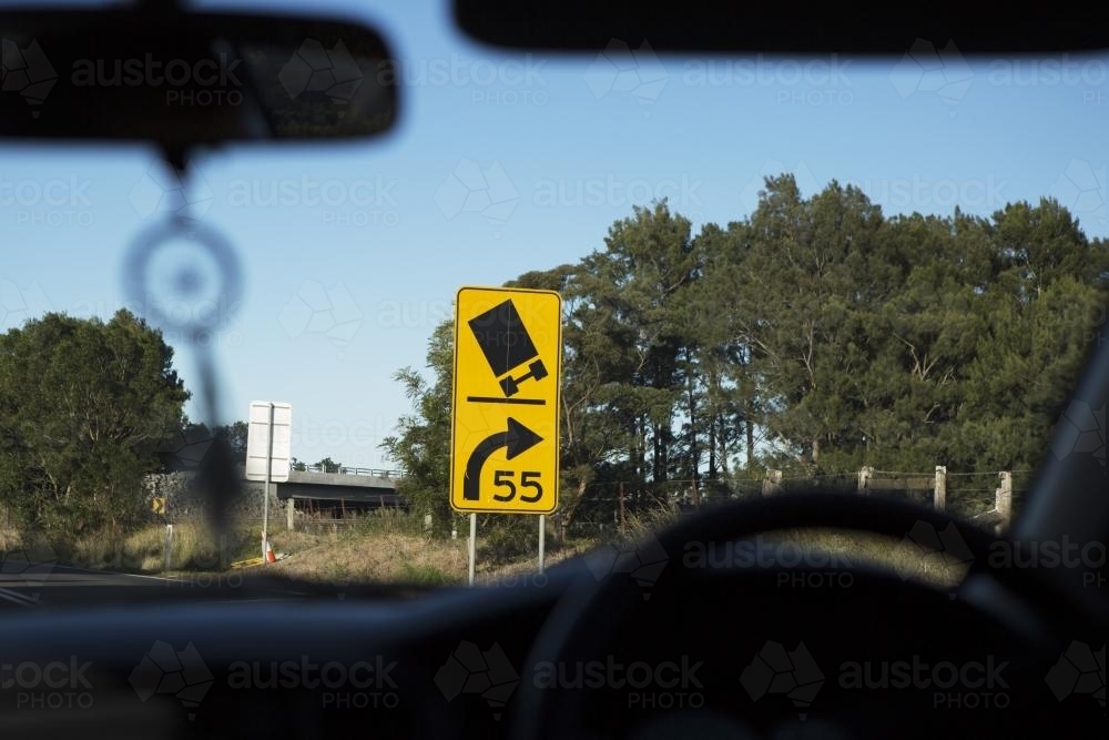 View out front car windscreen of a yellow road sign - Australian Stock Image
