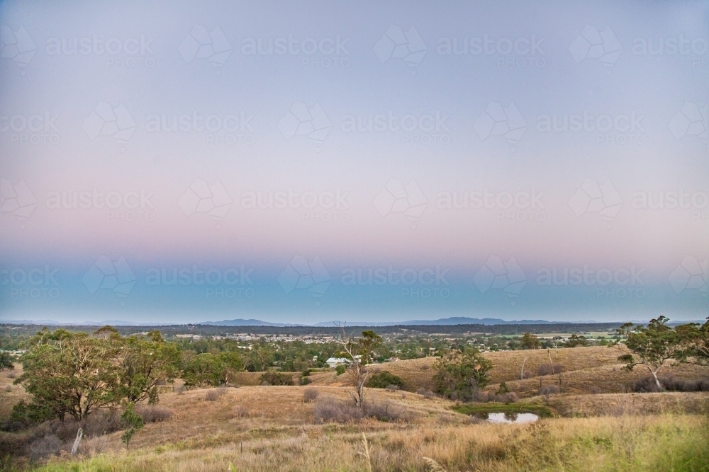 View over paddocks and dam at dusk - Australian Stock Image