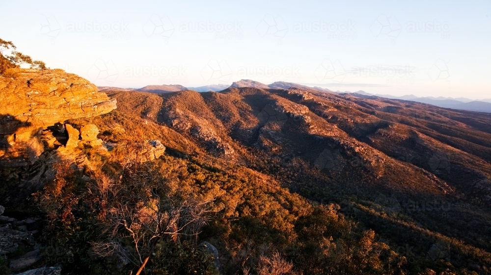 View over rocky mountain range in late afternoon - Australian Stock Image