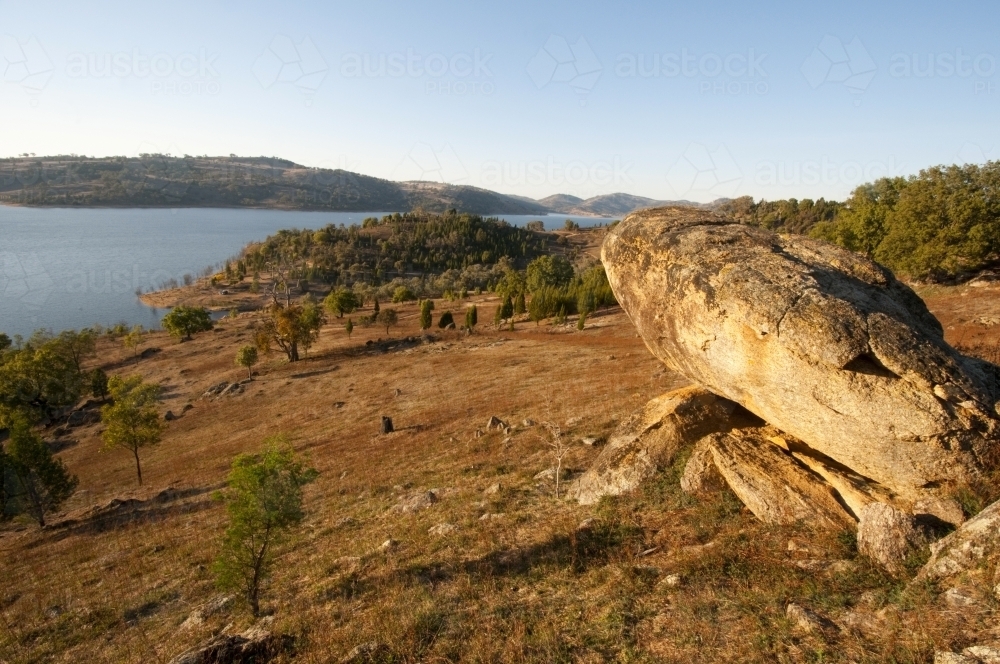 View over Wyangala Dam with boulder in the foreground - Australian Stock Image