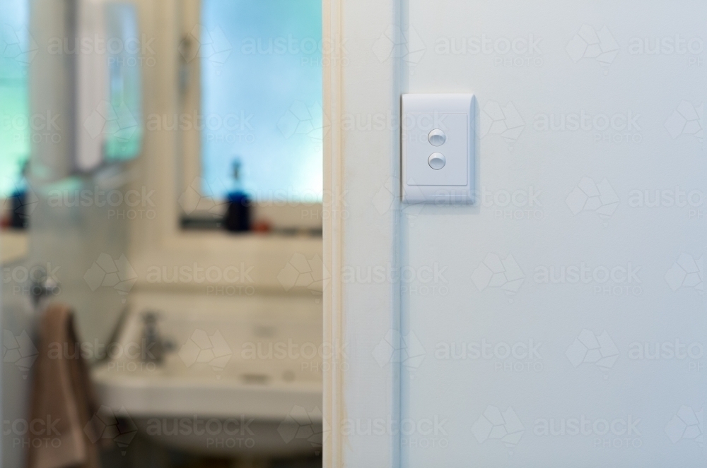 View through bathroom door with light switch - Australian Stock Image
