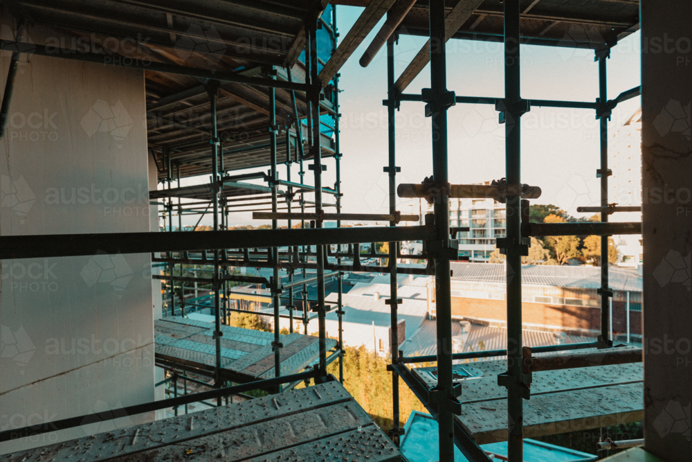 View through scaffolding on side of building in urban setting - Australian Stock Image
