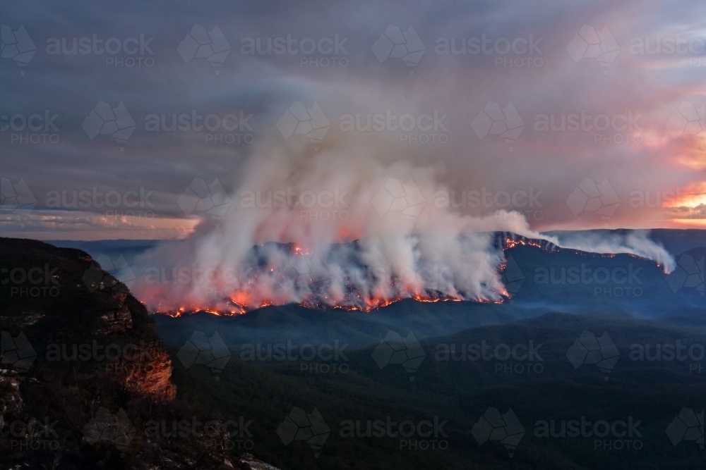 Views of the bush fire at Mount Solitary in Blue Mountains after sunset at dusk light - Australian Stock Image