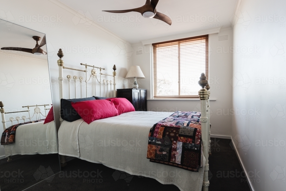 Vintage four poster brass bed in a guest bedroom - Australian Stock Image