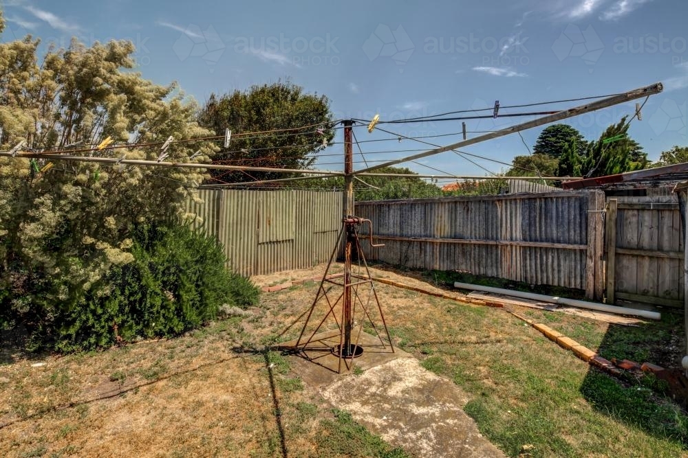 Image of Vintage Hills Hoist in backyard Austockphoto