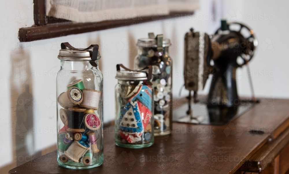 Vintage jars of sewing items with an old singer sewing machine - Australian Stock Image