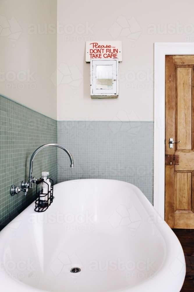 Vintage style bathroom with quirky retro safety sign on an old medicine cabinet - Australian Stock Image