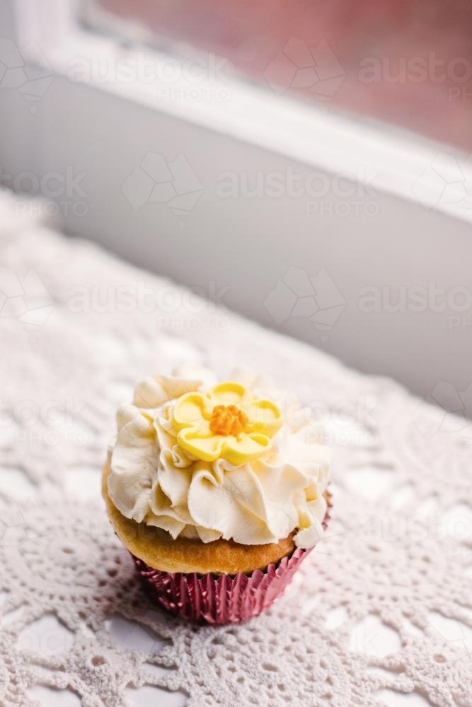 vintage style cupcake on doily - Australian Stock Image