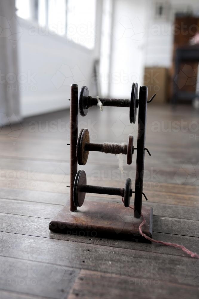 Vintage wooden spindle on floor boards inside a country house - Australian Stock Image