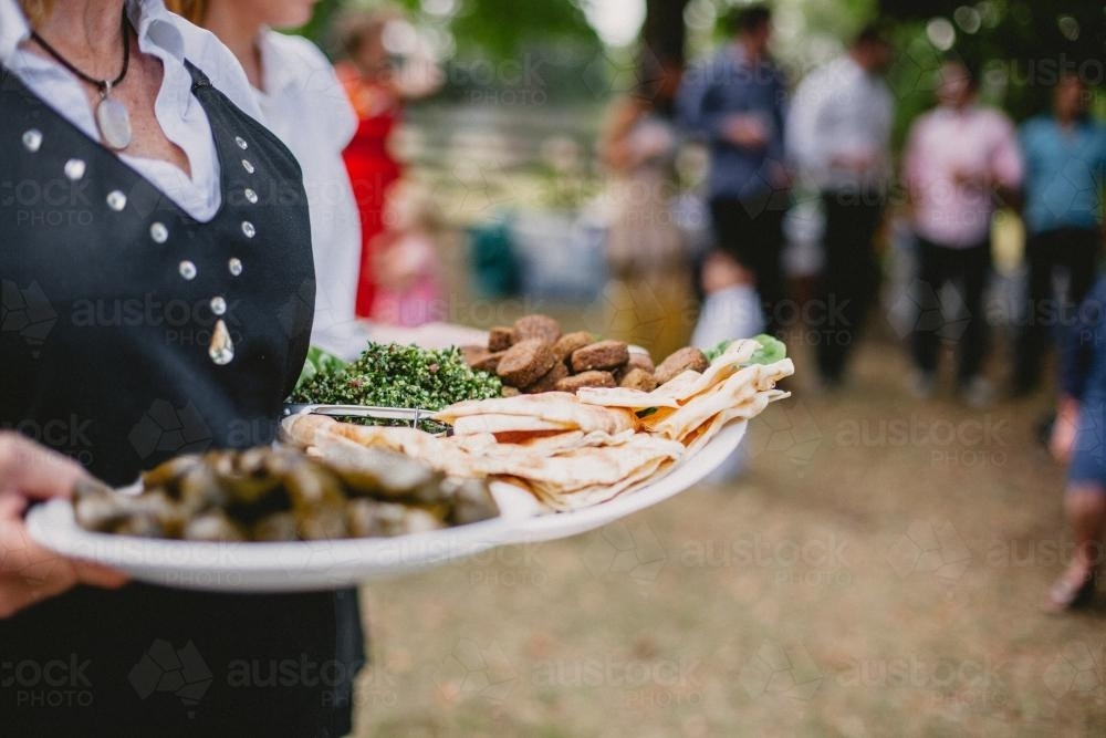 Waiter holding food at event - Australian Stock Image