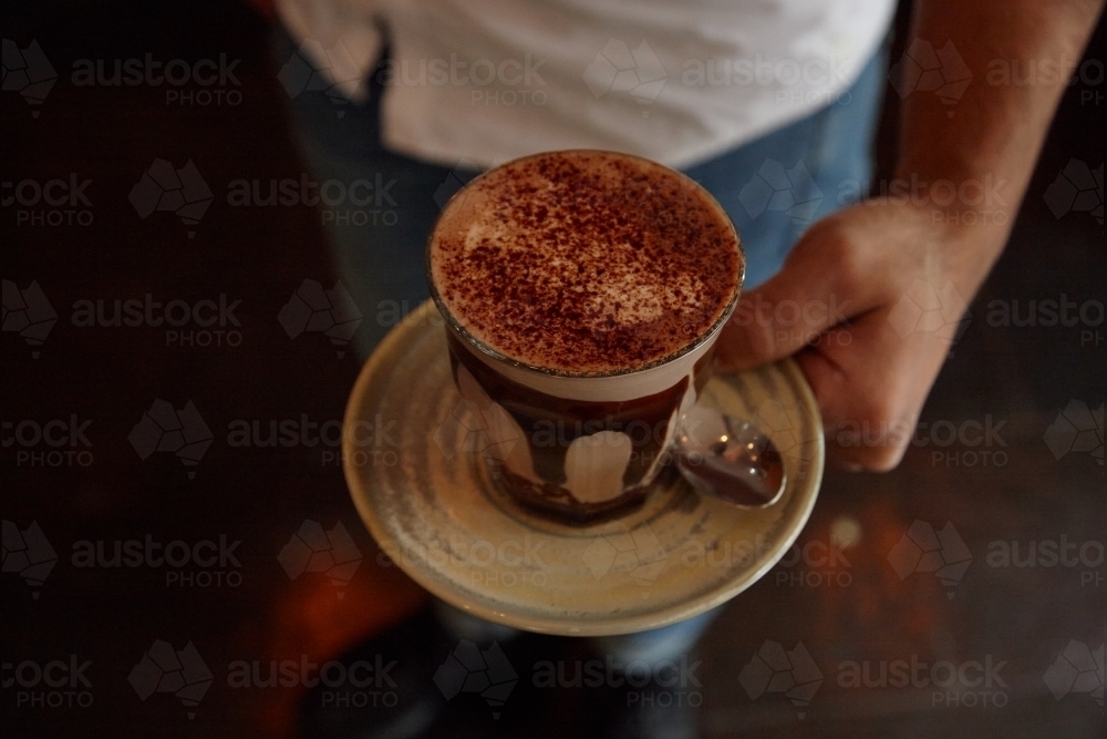 Waiter serving coffee - Australian Stock Image