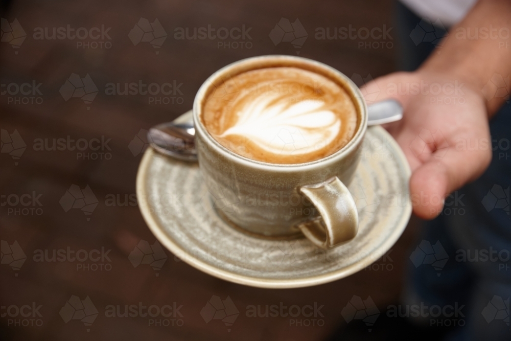 Waiter serving coffee - Australian Stock Image