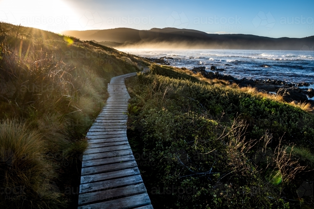 walking path beside the beach at sunrise - Australian Stock Image