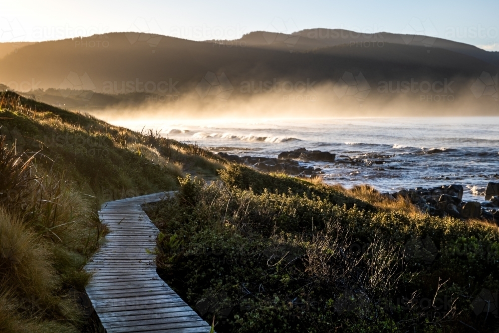 walking path beside the beach at sunrise - Australian Stock Image