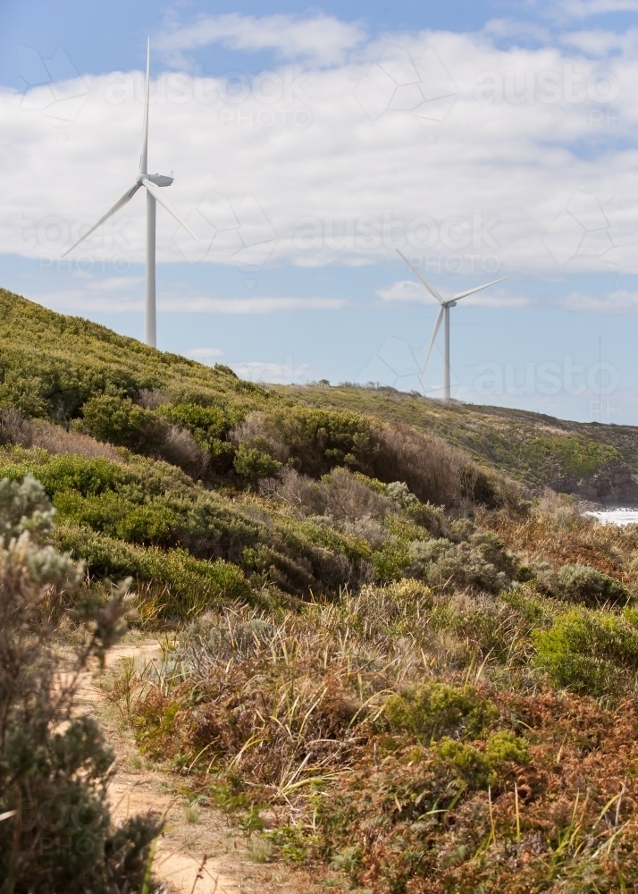 Walking track along coast near wind turbines - Australian Stock Image