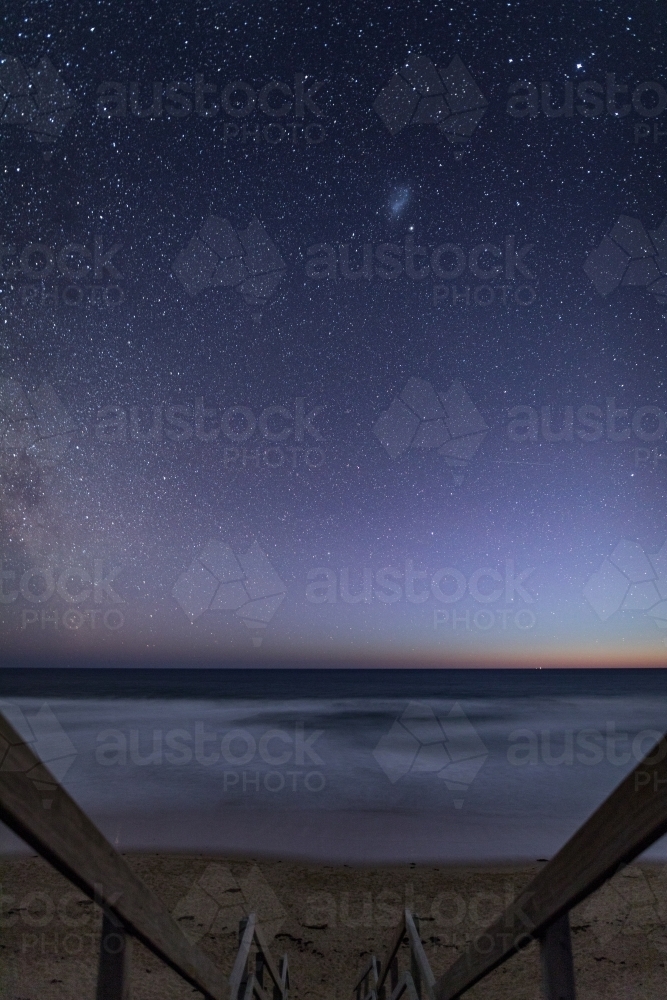 Walkway leading down to beach at night with stars - Australian Stock Image