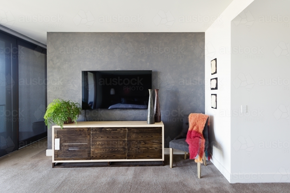 Wall mounted tv and buffet in spacious master bedroom - Australian Stock Image