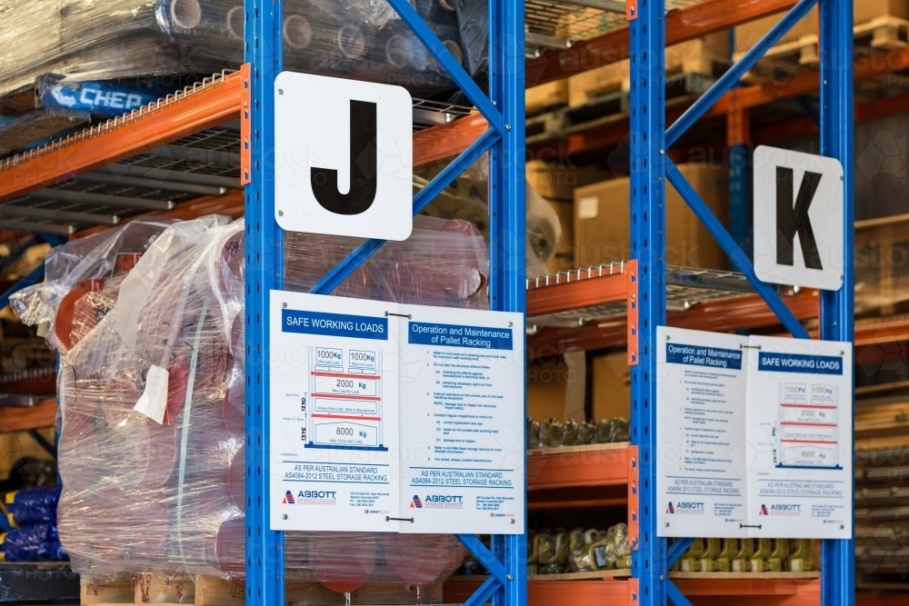 Image of Warehouse shelving and safety signs - Austockphoto