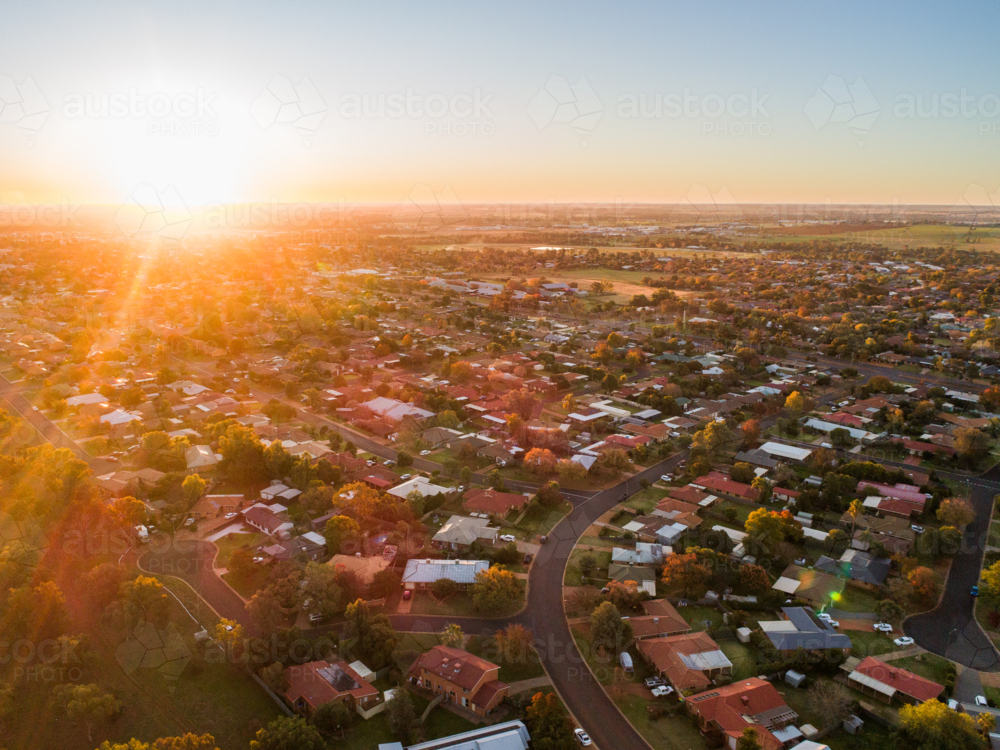 Warm golden sunset light over houses of suburb in inland Australian city of Dubbo - Australian Stock Image