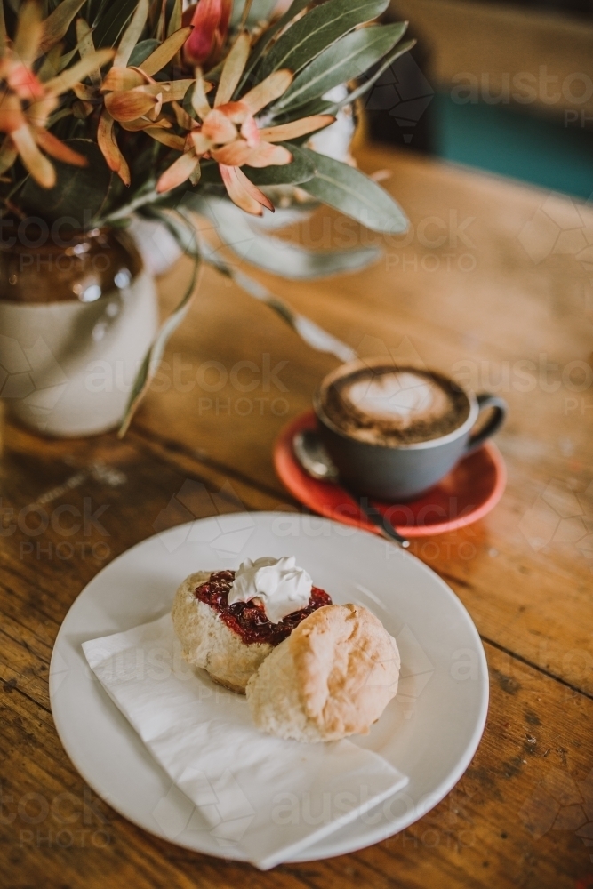 Warm scones beside coffee in a cup - Australian Stock Image