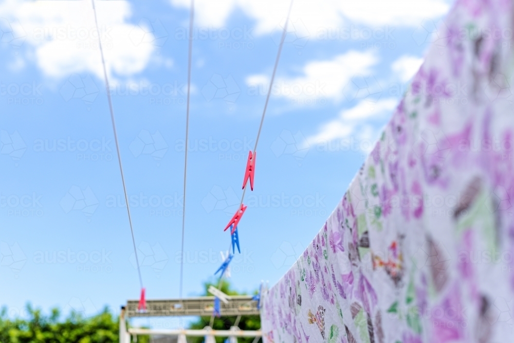 Washing hanging on the line drying in the wind - Australian Stock Image