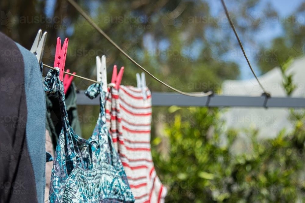 Washing pegged on to a clothes line to dry in the sun - Australian Stock Image