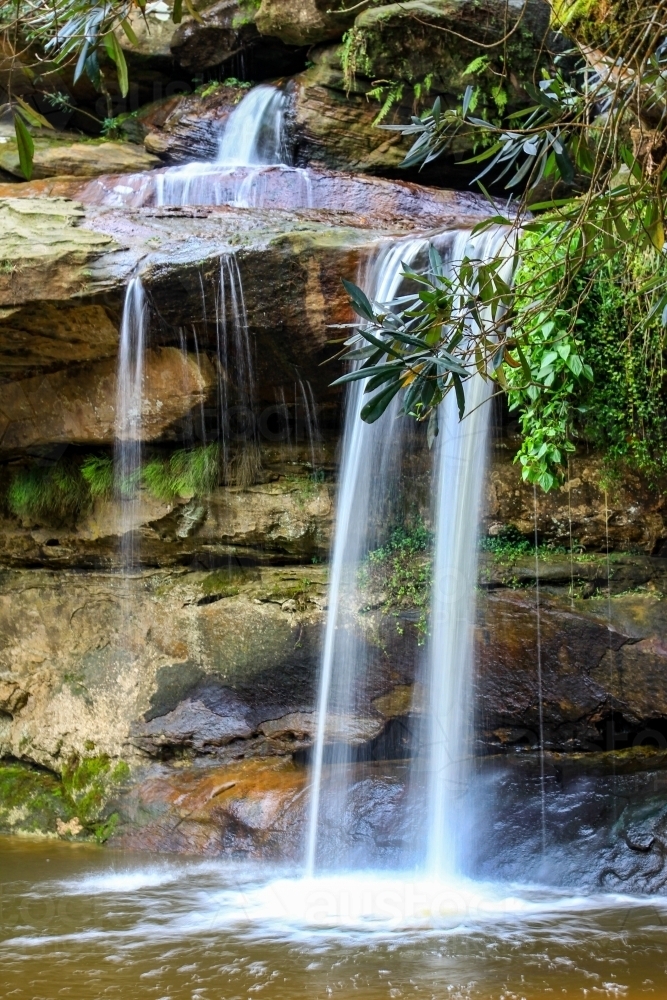 Water flowing over rocky waterfall - Australian Stock Image
