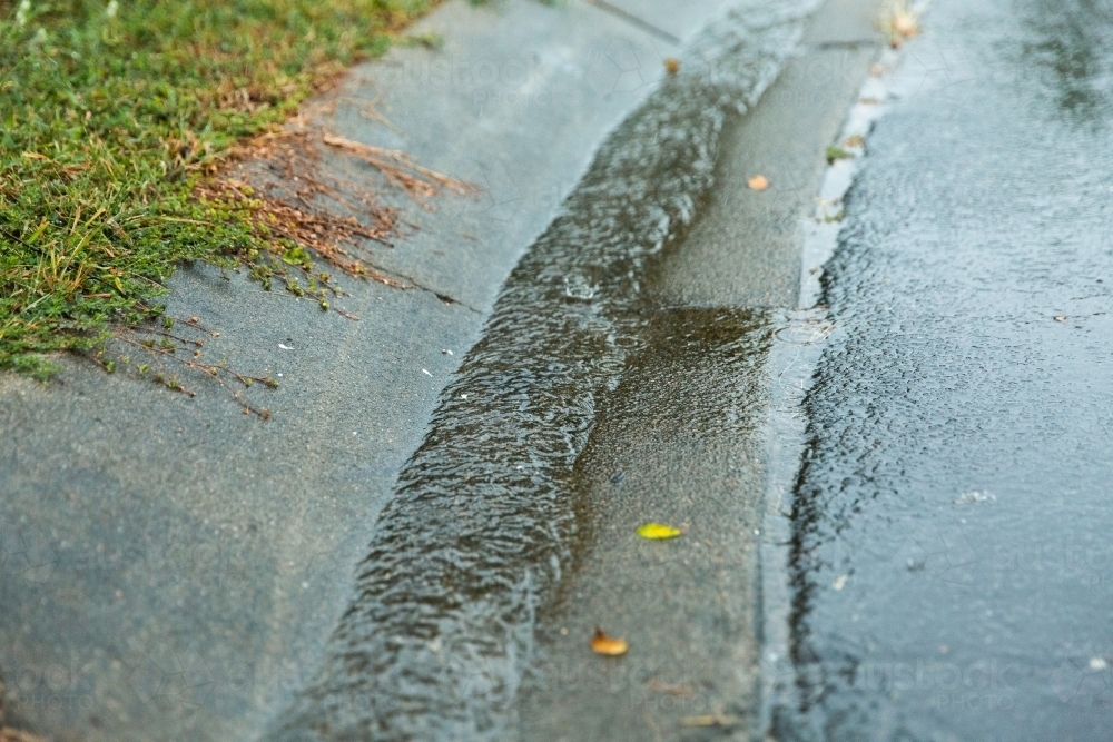 water in a gutter on a rainy day - Australian Stock Image