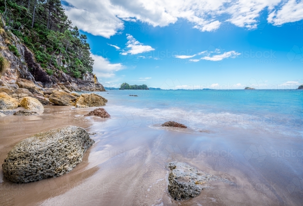 Water running back into the ocean on beautiful white sand beach - Australian Stock Image